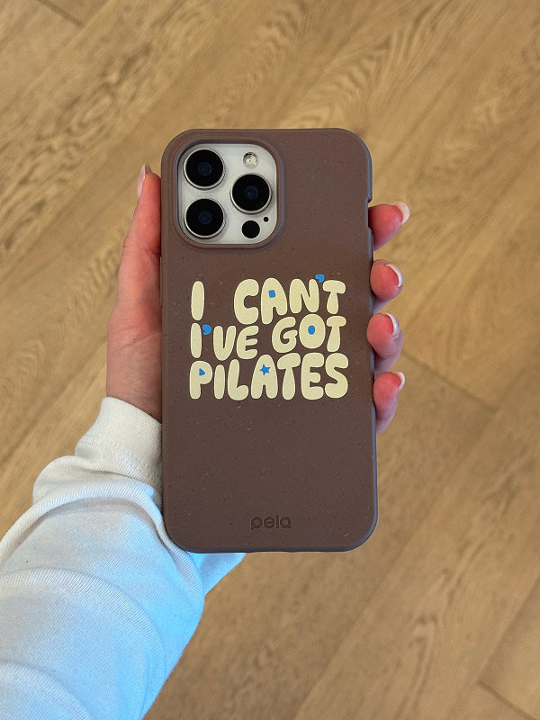 Pela Ive Got Pilates Phone Case in hand showing brown design with retro typography 